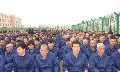 Detainee in a Xinjiang Re-education Camp located in Lop County listening to "de-radicalization" talks